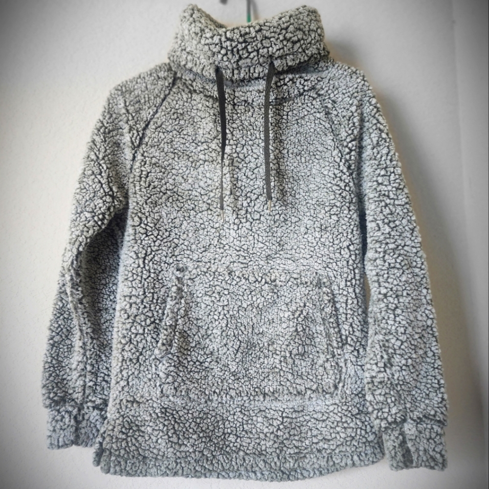 Cowl neck, sherpa sweater with front pocket.